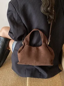 Minimalist dark brown suede leather shoulder bag with vintage style and golden hardware