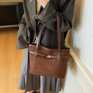 Vue détaillée du grand sac cabas marron en daim avec fermoir doré sur le modèle