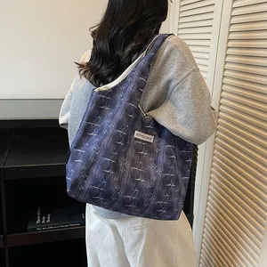 Detail of large tote bag with blue and purple brushstroke texture and white star pattern