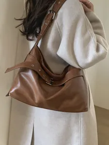 Large vintage brown faux leather tote bag with adjustable strap and metal hardware