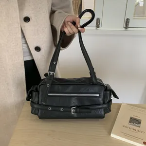 Detail view of black vintage motorcycle bag featuring silver buckles and adjustable straps