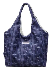 Dark blue starburst print tote bag with Kiss Yourself patch shown on white background