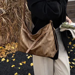 Large bronze hobo tote bag with metallic crinkled texture and adjustable shoulder strap