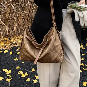 Close-up of retro brown tote bag with metallic texture and vintage vertical grain
