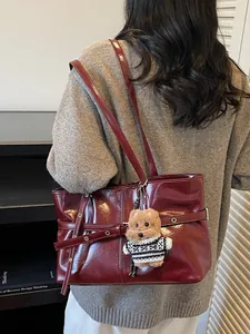Sac fourre-tout minimaliste en cuir verni bordeaux pour femmes avec breloque chiot