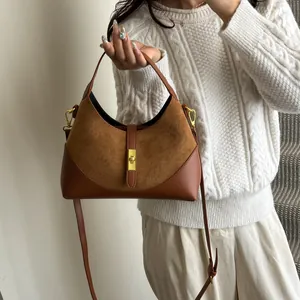 Brown contrast leather hobo bag styled on a white knit sweater for daily commute