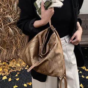 Detailed texture of the vintage bronze tote bag with retro metallic finish and grain