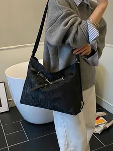Retro black textured tote bag with gold hardware shown as a large capacity shoulder bag
