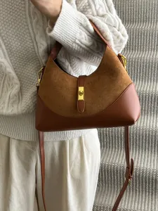 Brown suede patchwork dumpling bag with gold twist lock for crossbody or shoulder carry