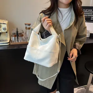 Dettaglio della borsa tote in pelle bianca con cuciture verticali e tracolla regolabile