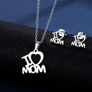 Detailed view of silver I Love Mom necklace and stud earring set on display pedestal