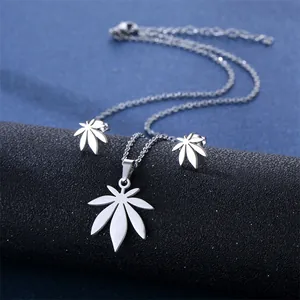 Macro shot of silver stainless steel necklace and seven-leaf clover earrings jewelry set