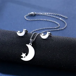 Detailed view of stainless steel celestial moon and star necklace and earrings set