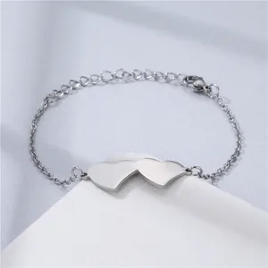Detail of adjustable silver stainless steel bracelet featuring minimalist double hearts