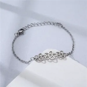 Detail of silver stainless steel ocean style bracelet with three hollow flower charms