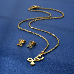 Golden stainless steel necklace and earrings set featuring Arabic letter and heart pendant