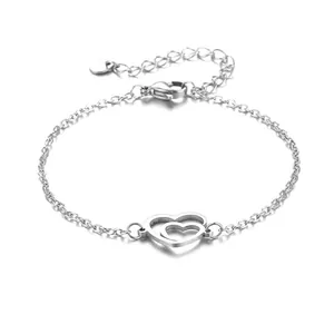Minimalist stainless steel bracelet featuring interlocking heart charms on link chain