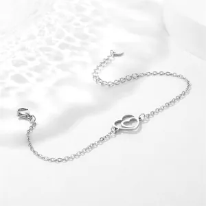 Detail of silver hollow double heart charms on a delicate O-chain with lobster clasp