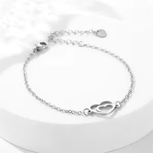 Detail of silver stainless steel double heart pendant bracelet with O-chain and lobster clasp