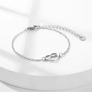 Minimalist silver stainless steel bracelet featuring interlocking hollow heart charms