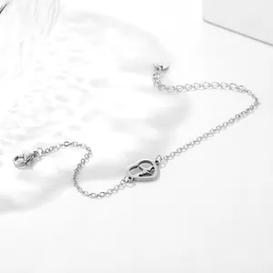 Macro view of stainless steel heartbeat heart pendant bracelet with lobster clasp
