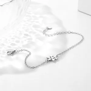 Detailed view of silver snowflake pendant on stainless steel chain with lobster clasp