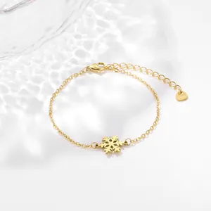 Minimalist gold snowflake bracelet in stainless steel with adjustable heart charm chain