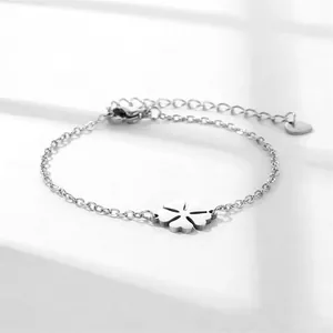 Polished stainless steel four-leaf clover bracelet with adjustable chain on white surface
