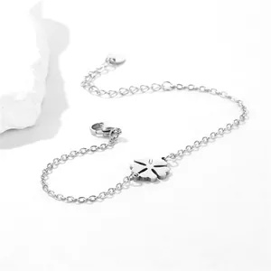 Macro view of silver stainless steel flower bracelet with clover charm and lobster clasp