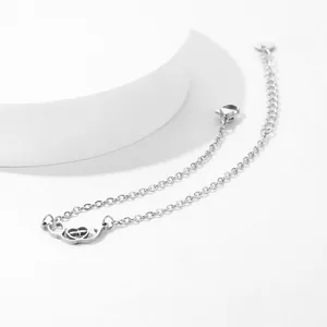 Macro shot of silver stainless steel stethoscope bracelet with heart pendant and O-chain