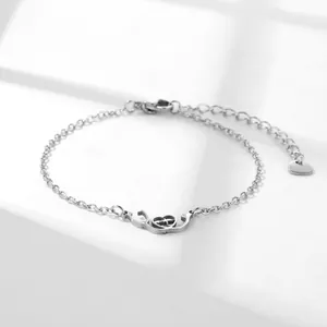 Polished stainless steel stethoscope heart pulse bracelet on minimalist white steps
