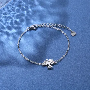 Macro view of stainless steel Tree of Life charm bracelet with water ripple reflection