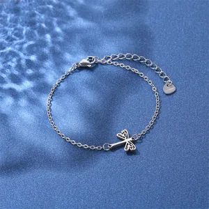 Macro detail of stainless steel dragonfly bracelet with heart tag and lobster clasp