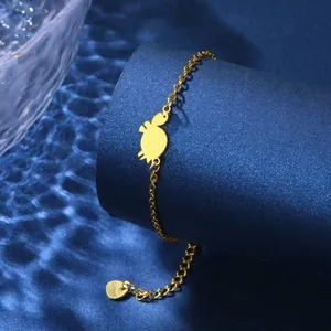 Golden stainless steel turtle pendant bracelet on a ripple blue background