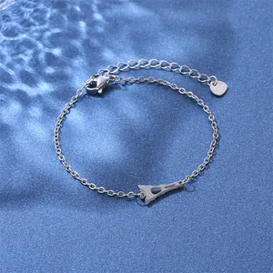 Close-up of stainless steel bracelet with Eiffel Tower charm and S.Steel heart tag
