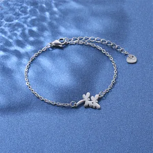 Macro detail of stainless steel dragonfly bracelet with lobster clasp and S.Steel heart tag