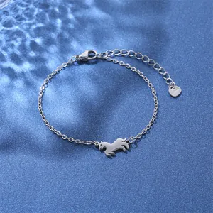 Macro shot of stainless steel horse pendant bracelet on blue rippled background