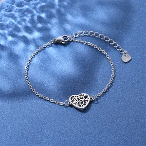 Detailed macro view of silver stainless steel lobster clasp and hollow heart charm