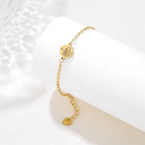 Macro shot of gold stainless steel tree of life pendant on O-chain with lobster clasp