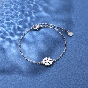 Polished stainless steel four-leaf clover bracelet on water ripple blue background