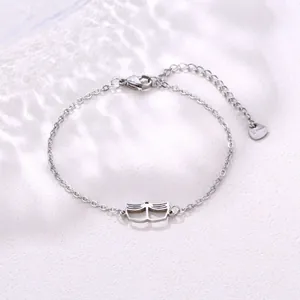 Macro detail of silver stainless steel chain with a hollow cat face pendant charm