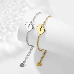 Minimalist stainless steel bracelet with baby feet charms in gold and silver finish