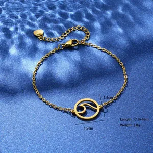 Detail of gold ocean wave pendant bracelet with size measurements and blue water texture