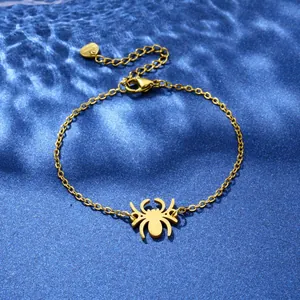 Elegant gold spider pendant bracelet with adjustable chain on blue wavy silk background