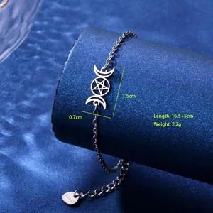Detailed macro view of silver moon pentagram charm bracelet with lobster clasp and heart tag