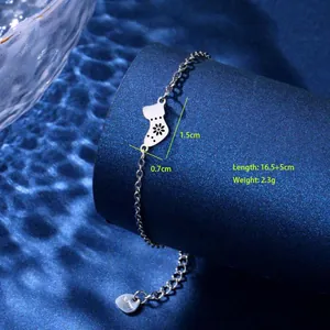 Macro shot of stainless steel kitten charm bracelet with hollow flower pattern and measurements
