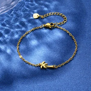 Gold stainless steel coconut tree bracelet for beach vacations on blue satin fabric