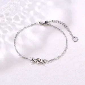 Detailed close-up of stainless steel bracelet with triple moon and pentagram charms