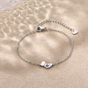 Detailed close-up of stainless steel bracelet with Christmas sock pendant and heart charm