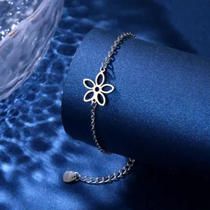 Macro view of silver stainless steel bracelet with cutout flower and chain detail